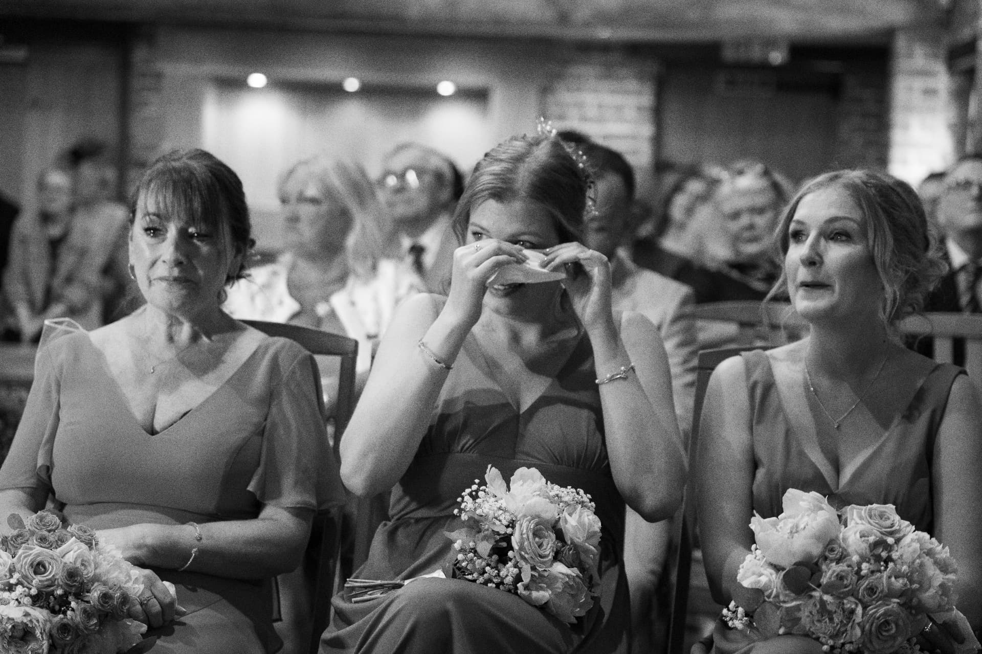Bridesmaids sharing an emotional moment during the ceremony