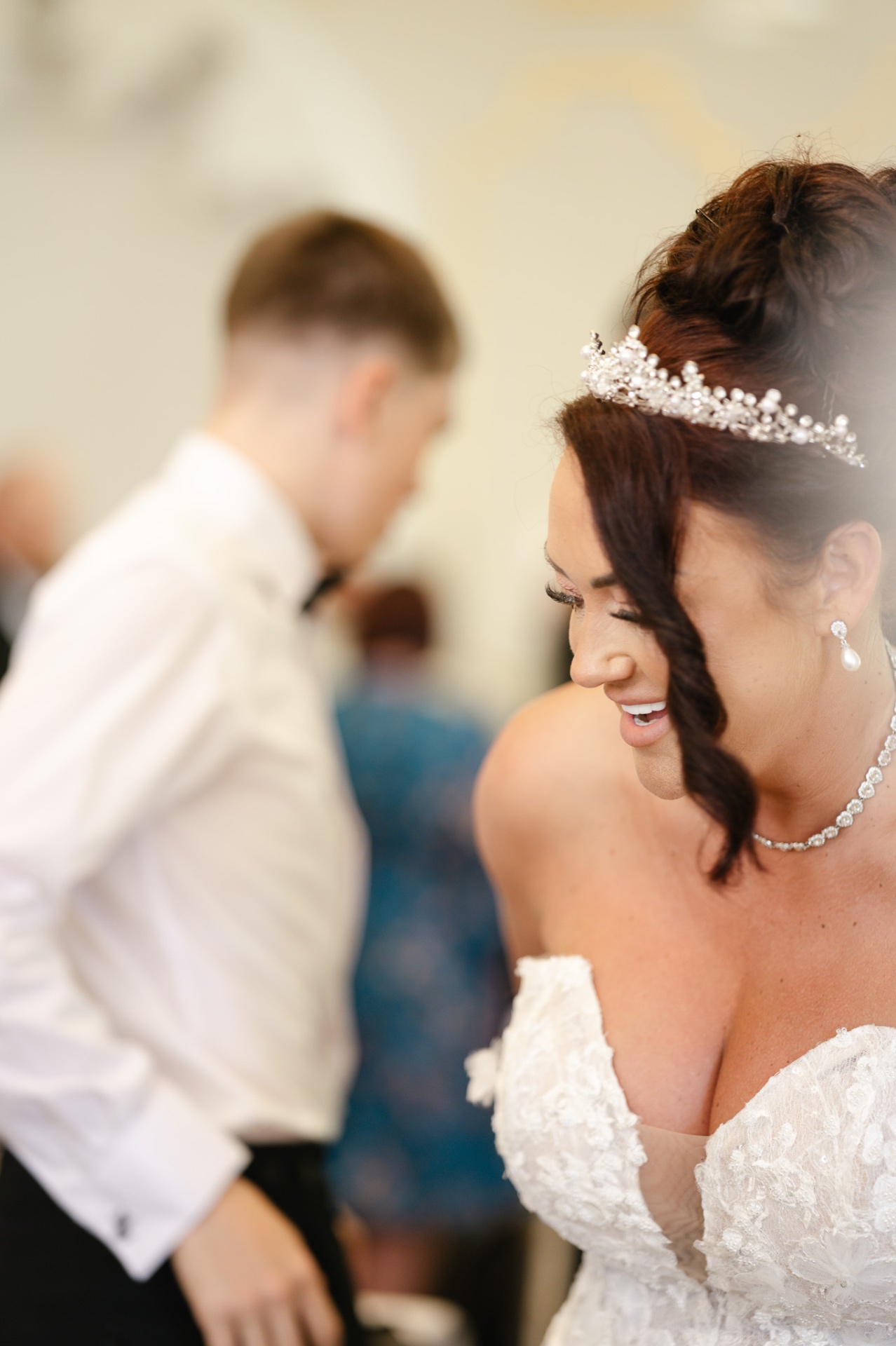 Quiet candid portrait of the bride smiling, tiara catching the light, wedding photography Worcestershire & Midlands