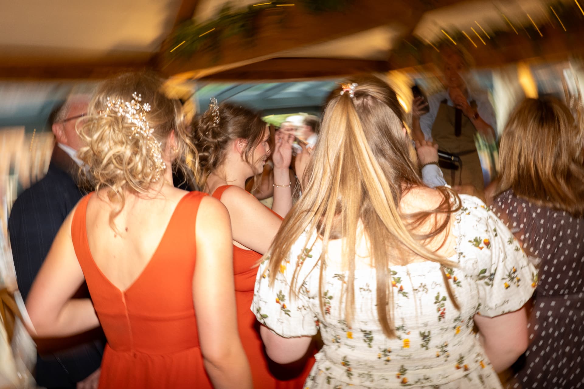 Bridesmaids dancing under festoon lights at the evening reception, wedding photography Worcestershire & Midlands